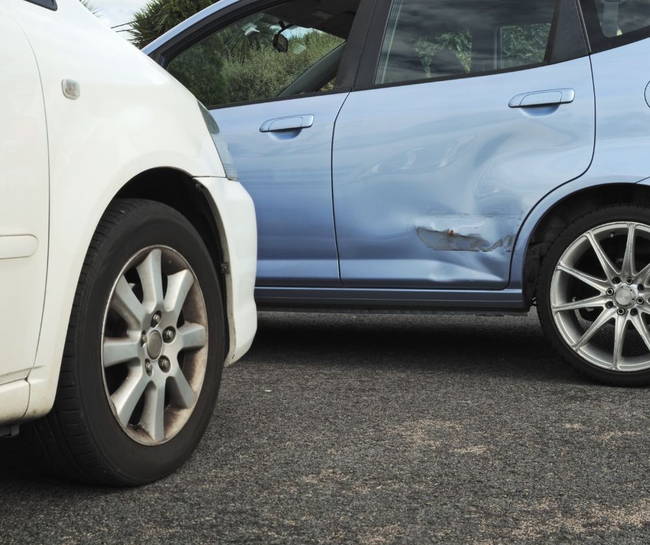 Collision damage on a blue vehicle awaiting auto body repair in Pasco, WA.